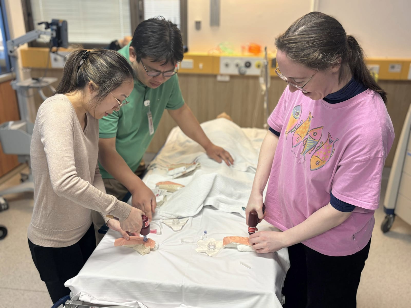 Registrars practising IO drilling on training pads