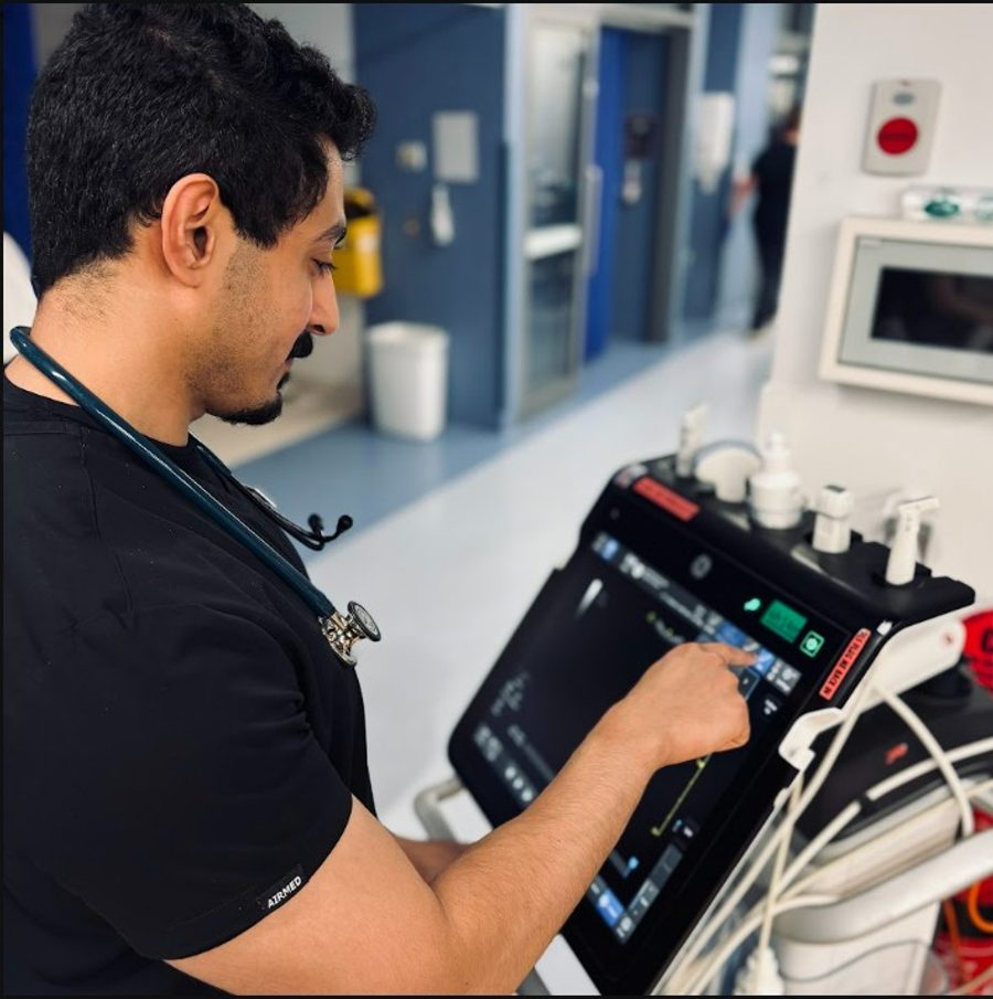A registrar operating a point-of-care ultrasound machine in the emergency department